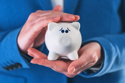 Worried and afraid piggy coin bank in hands of professional businesswoman